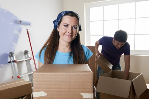 Local moving truck loading household furniture in Highbury