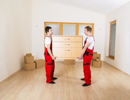 Local moving team handling packed boxes during a Highbury home relocation